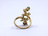 an image of a gold ring with a geckole on it