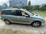 the small car is parked on the side of the road