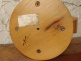 a wooden clock sitting on top of a wooden shelf