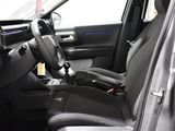 the interior of a car with a black leather seat and steering wheel