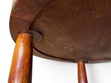 a close up of a wooden chair with two wooden legs