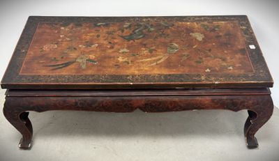 an old wooden table with a floral design on top of it