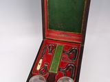 a wooden box with silverware in it on a white surface