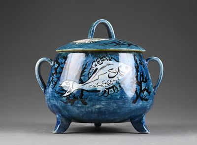 a blue and white bowl with a lid on a stand