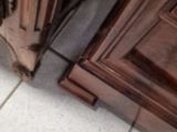 a cat that is sitting on the floor in front of a door