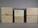 three boxes with writing on them are lined up against a gray background