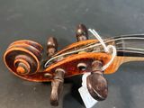 a close up of a violin that is laying on a table