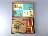 a small wooden box with a toy house inside of it