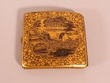 an image of a gold cigarette case with a picture of a castle