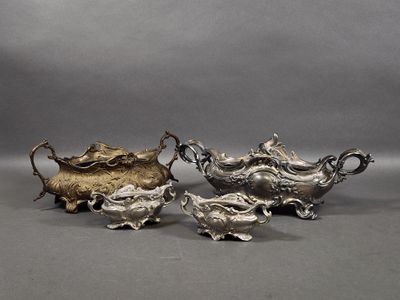 a pair of silverplated teapots with handles and handles
