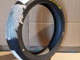 a tire that is sitting on the floor in front of a cardboard box