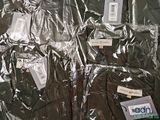 a lot of clothing wrapped in plastic on a table