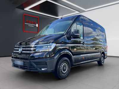 a black van is parked in a large room
