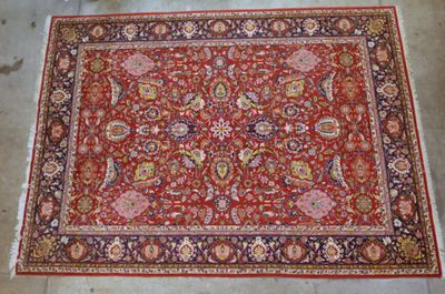 a red rug with a floral design on it