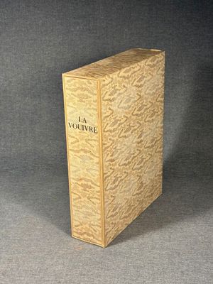 an old book sitting on top of a table next to a black background