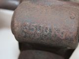 a rusted metal pipe with a rusted handle on it