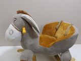 stuffed donkey sitting on a wooden sled with wheels on a white surface