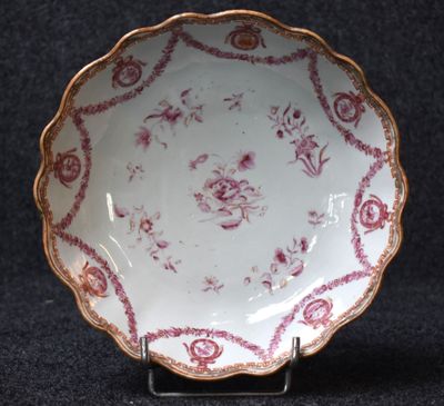 an image of a white and red plate on a black surface