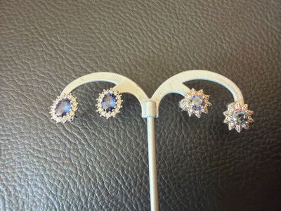 a close up of a pair of earrings sitting on top of a table