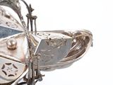a silver plate with a bird on top of it