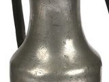 two silver vases sitting next to each other on a table