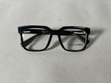 a close up of a pair of glasses on a white surface