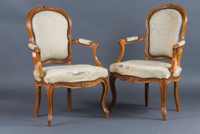 pair of louis xv style walnut armchairs with upholstered upholstered seats