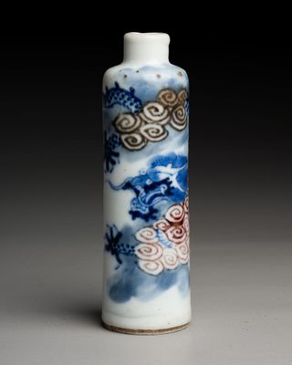 a blue and white vase with a dragon design on it