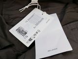 an image of a close up of a person ' s jacket with a tag on it