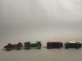 several toy trains are lined up in a row on a white surface