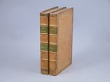 an old book sitting on top of a white surface