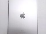 an apple ipad sitting on top of a white table next to a white wall