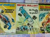 two books on the wall of a room with a blue car and a red car