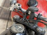 a close up of a red motorcycle with a black handlebar