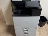 a black and white printer sitting on top of a wooden floor