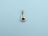 a gold pendant with a blue sapphire stone on it