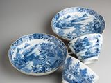 three blue and white dishes and cups on a gray surface