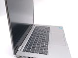 a silver laptop computer sitting on top of a white table