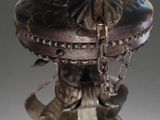 a bronze statue of a man with a hat on top of a table