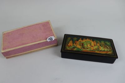 a small box with a painting on it next to a smaller box with a painting on it