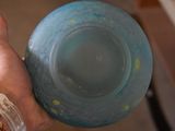 a person holding a blue bowl with sprinkles in it