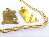 a gold necklace with a piece of jewelry on it