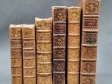 several old books stacked on top of each other on a table