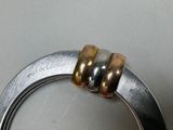 a silver ring with two gold rings on top of it