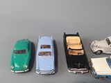 several toy cars are lined up in a row on a table