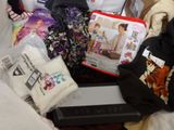 a pile of children ' s clothing and toys on a bed