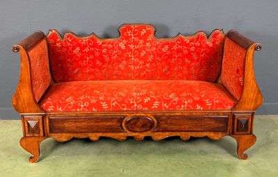 a wooden bench with a red upholstered seat