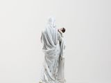figurine of a woman dressed in a white robe and veil