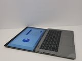 a laptop computer sitting on top of a white table