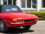 an image of a red convertible car parked in a parking lot